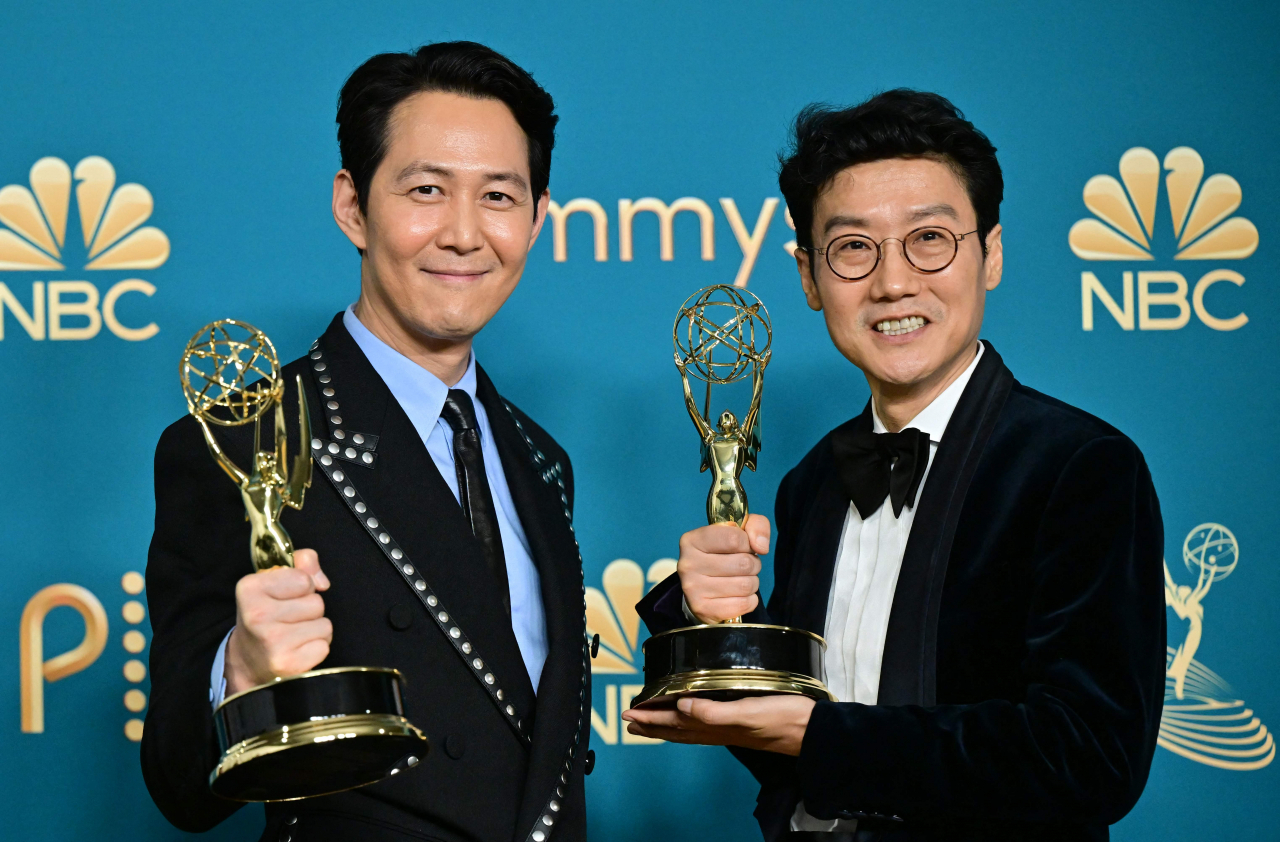 South Korean actor Lee Jung-jae (left) poses with the award for outstanding lead actor in a drama series and South Korean director Hwang Dong-hyuk (right) with the Emmy for outstanding directing for a drama series for 