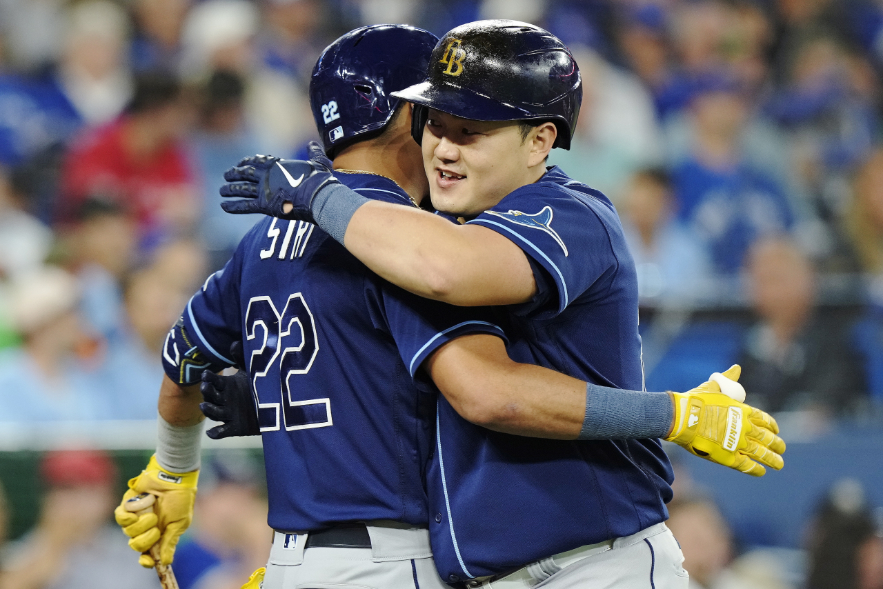 In this Getty Images photo, Choi Ji-man of the Tampa Bay Rays (R) embraces teammate Jose Siri after hitting a solo home run against the Toronto Blue Jays in the top of the third inning of a Major League Baseball regular season game at Rogers Centre in Toronto on Tuesday. (Getty Images)
