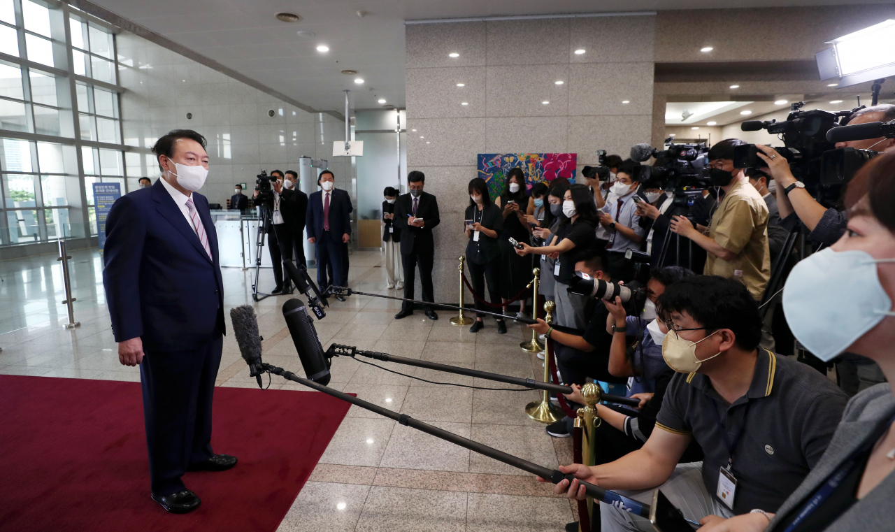 President Yoon Suk-yeol speaks to reporters on his way to the presidential office in Yongsan, Seoul, Friday. (Yonhap)