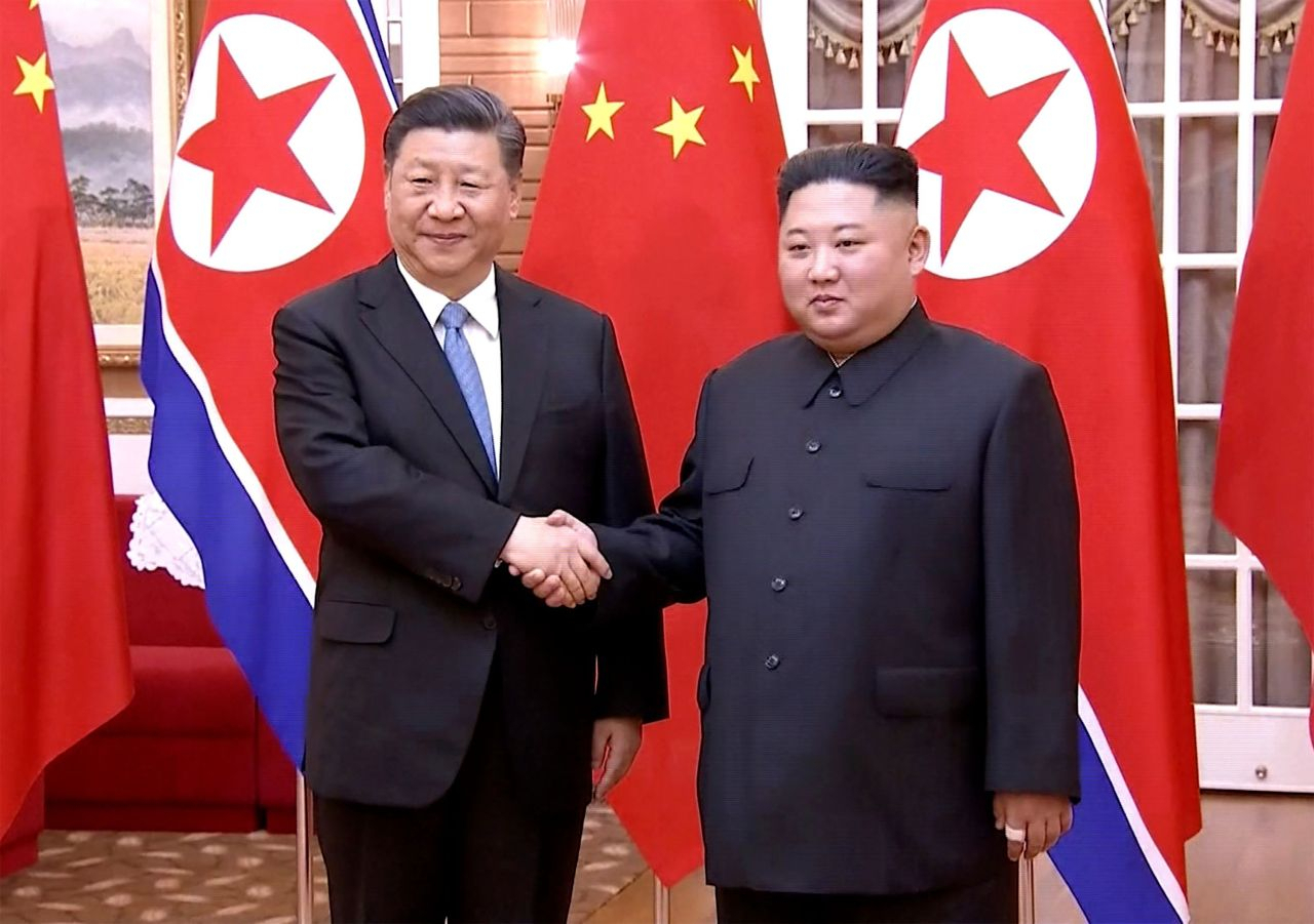 This screengrab taken of a video released by CCTV on June 20, 2022 shows Chinese President Xi Jinping (left) shaking hands with North Korean leader Kim Jong-un during their meeting in North Korea's capital Pyongyang. (AFP-Yonhap)