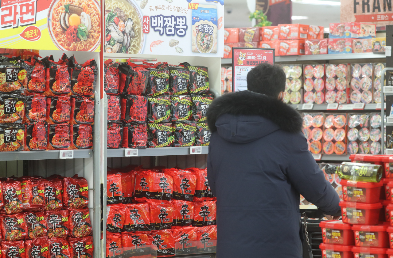 A shopper looks at instant noodles at a supermarket in Seoul. (Yonhap)