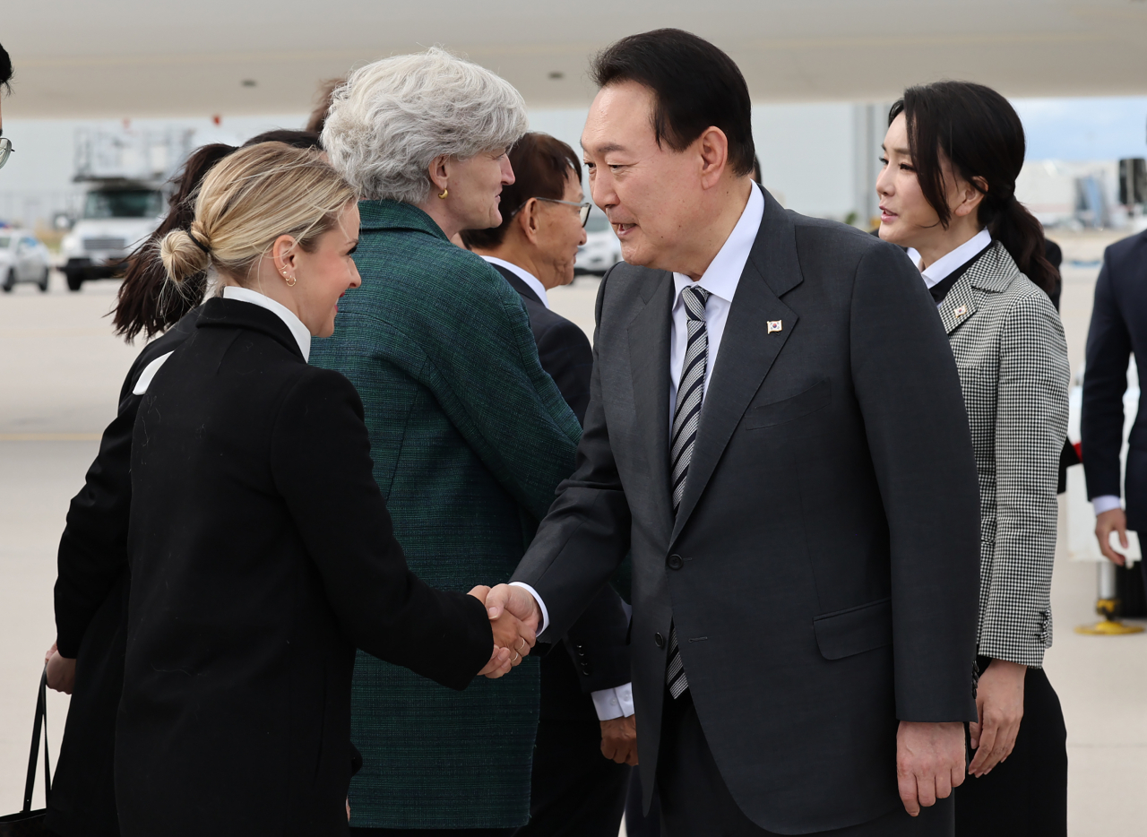 President Yoon Suk-yeol and first lady Kim Keon-hee arrive at Pearson International Airport in Toronto, Canada on Thursday (local time) and shake hands with welcoming figures. (Yonhap)