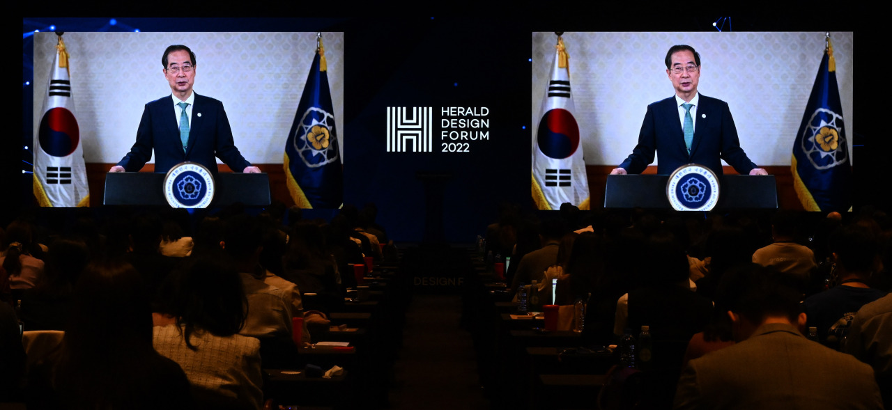 Prime Minister Han Duck-soo is shown delivering a video message on Tuesday at the Herald Design Forum 2022 at Hotel Shilla in Seoul. (Im Se-jun/The Korea Herald)