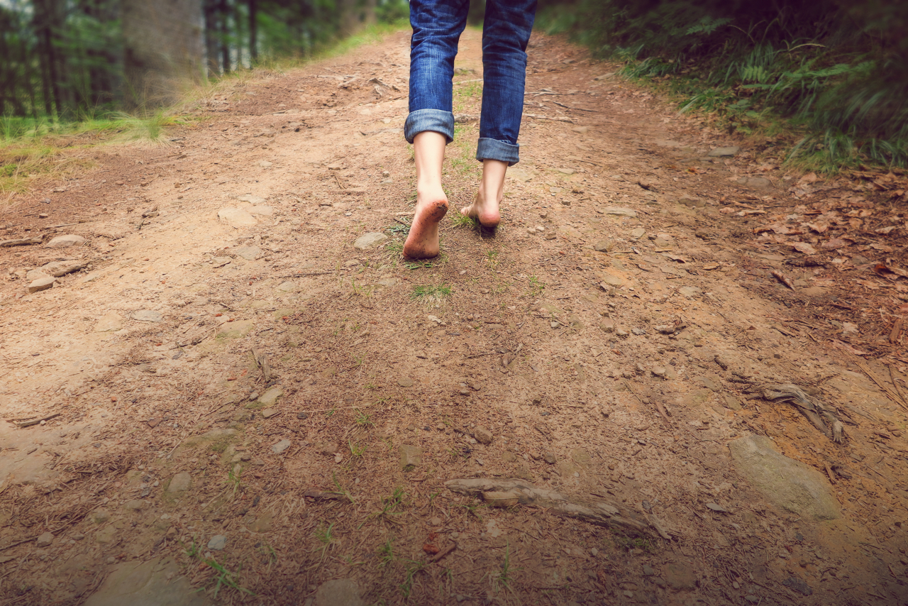 A man walks barefoot on a trail. (123rf)
