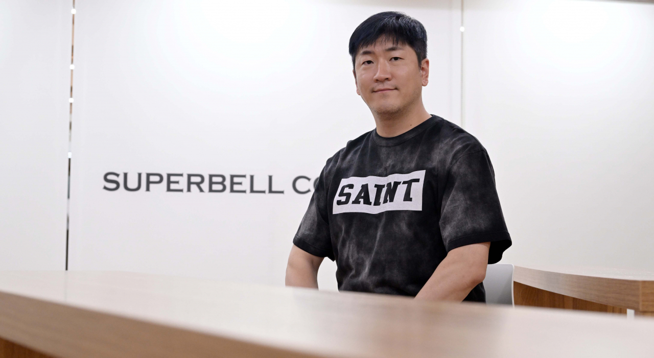 Veteran K-pop producer Ryan Jhun poses for photos during a recent interview with The Korea Herald at Superbell Company's headquarters in Mapo-gu, western Seoul. (Lee Sang-sub/The Korea Herald)