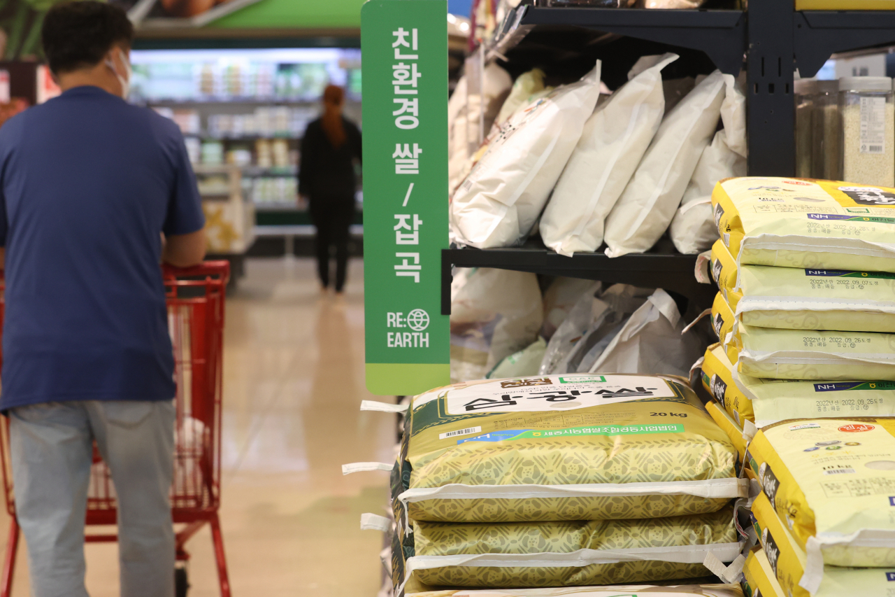 A shopper passes by bags of rice at a supermarket in Seoul on Monday. (Yonhap)