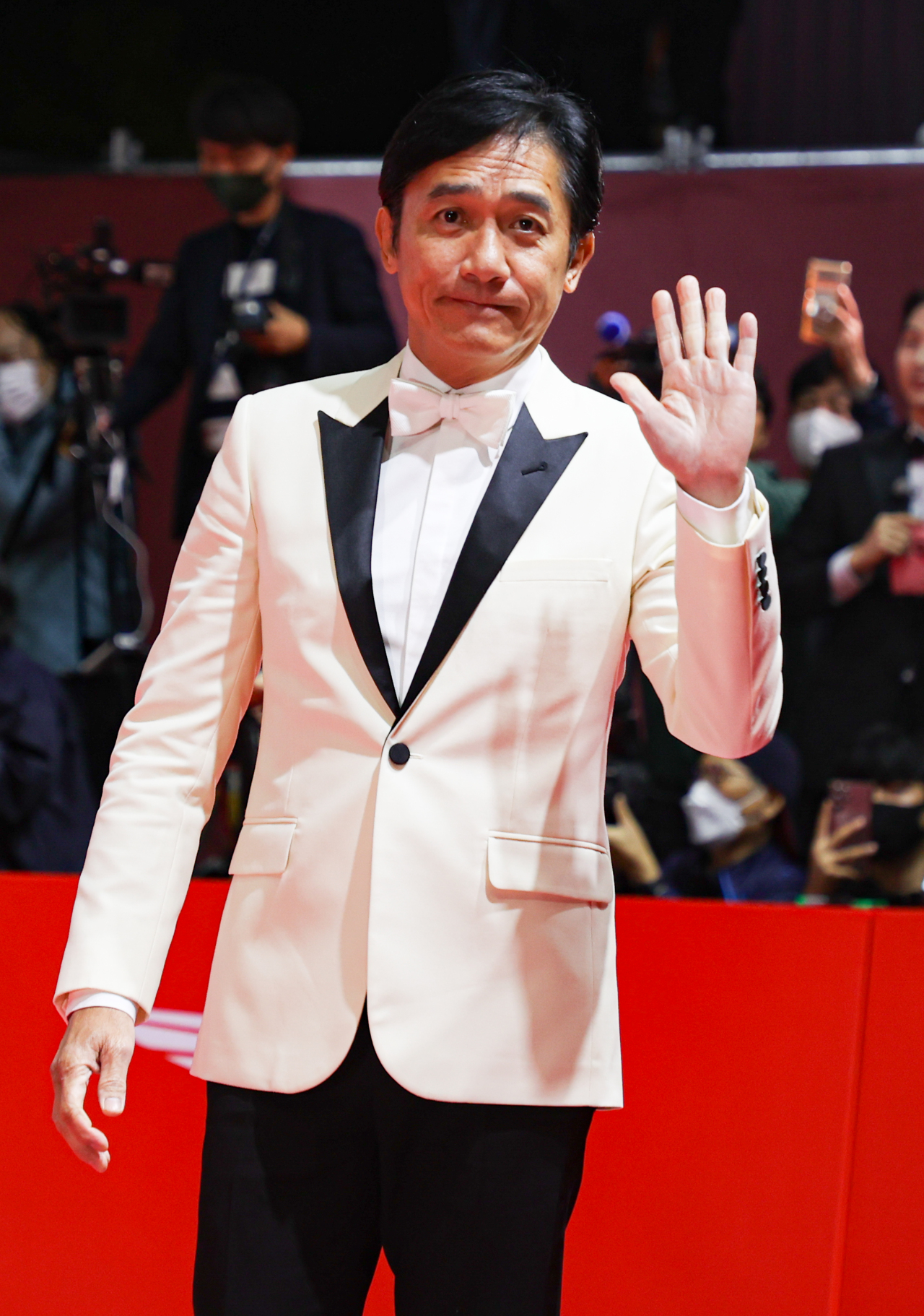 Hong Kong actor Tony Leung Chiu-wai poses for photos during the red carpet event of the 27th Busan International Film Festival on Wednesday at the Busan Cinema Center. (Yonhap)