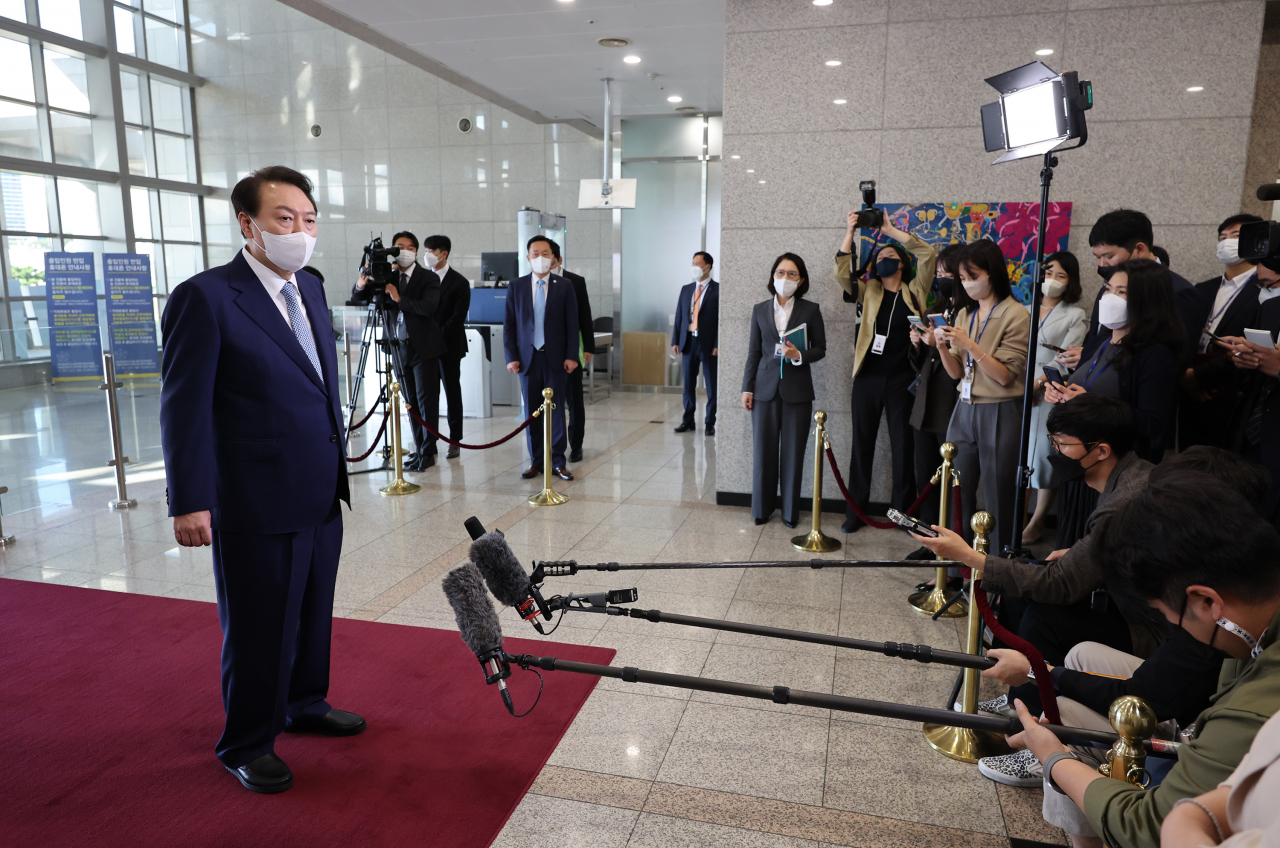 President Yoon Suk-yeol speaks to reporters as he arrives at the presidential office in Seoul on Friday. (Yonhap)