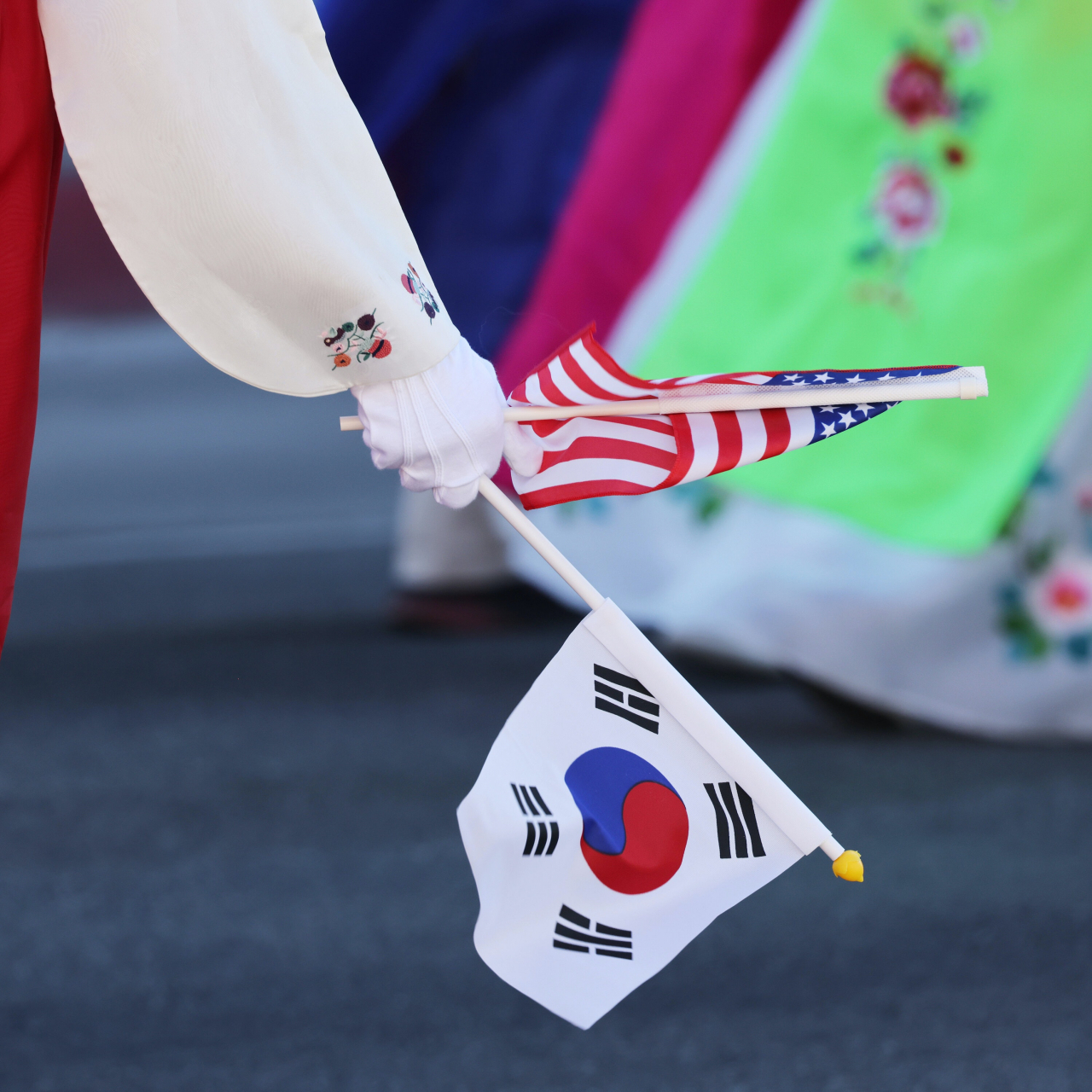 The national flags of the US and South Korea are held by a hanbok-wearing participant at the 49th annual Korean Festival Parade in Los Angeles Koreatown on Sept. 24.Photo © Hyungwon Kang