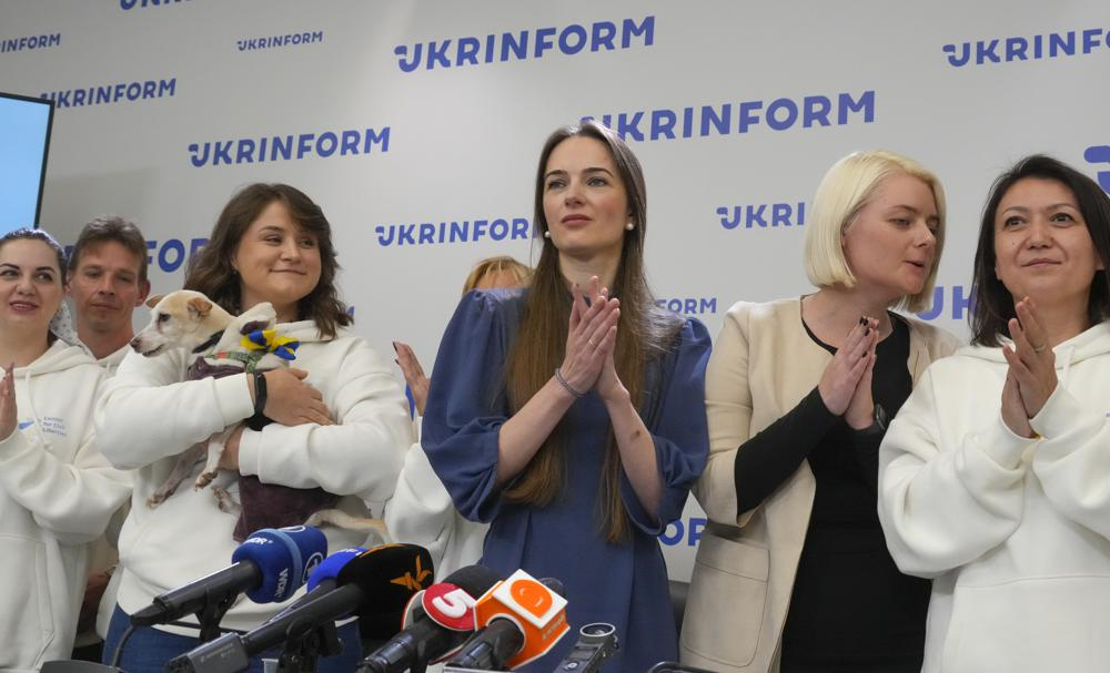 Center for Civil Liberties head of the board Oleksandra Matviychuk, center, executive director Oleksandra Romantsova, center left, and managers react after press conference in Kyiv, Ukraine, Saturday. On Friday, Friday, the Nobel Peace Prize was awarded to jailed Belarus rights activist Ales Bialiatski, the Russian group Memorial and the Ukrainian organization Center for Civil Liberties. (AP Photo/Efrem Lukatsky)