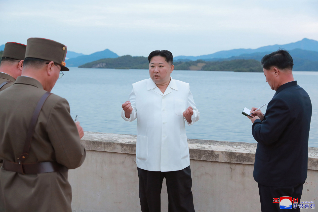This photo, provided by the Korean Central News Agency on Monday shows North Korean leader Kim Jong-un talking to military officials during his inspection of major drills. (KCNA)