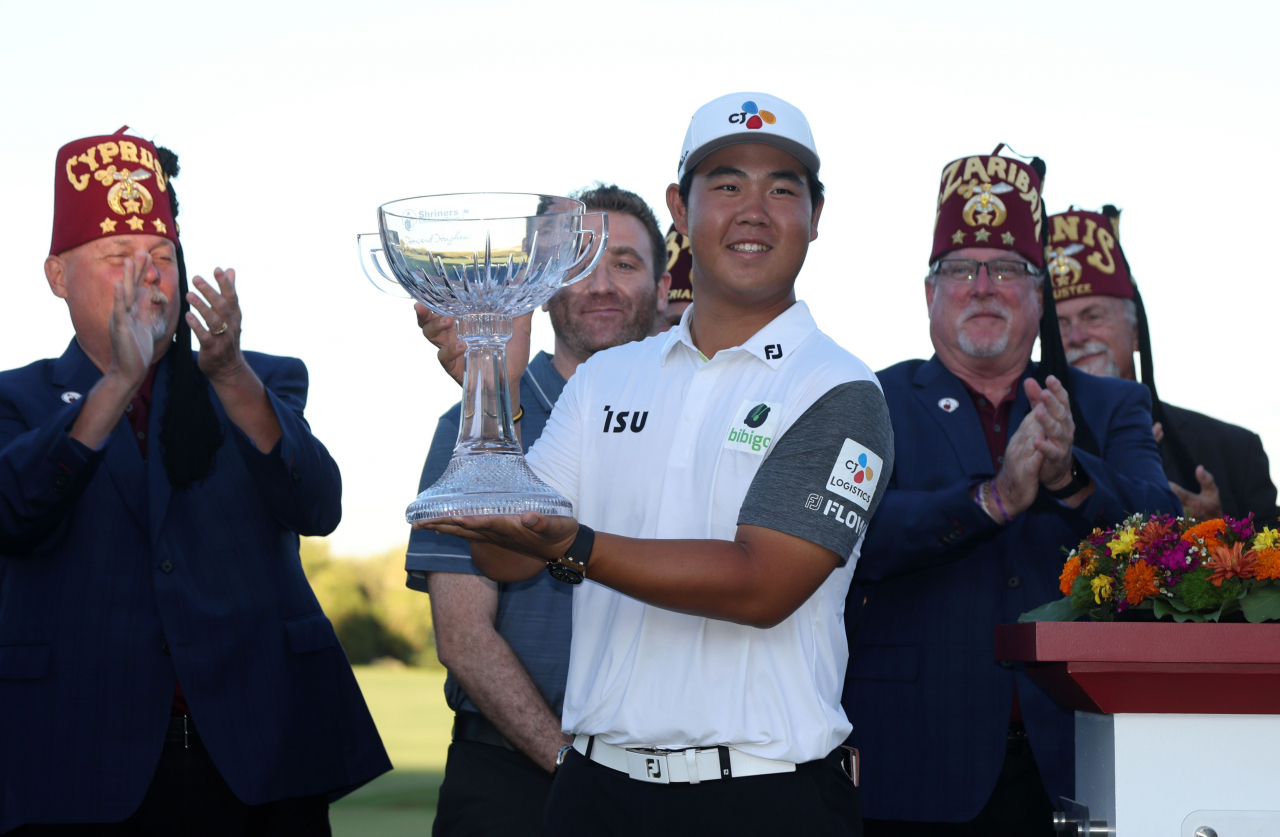 In this Getty Images photo, Kim Joo-hyung of South Korea hoists the trophy after winning the Shriners Children's Open at TPC Summerlin in Las Vegas on Sunday. (Getty Images)
