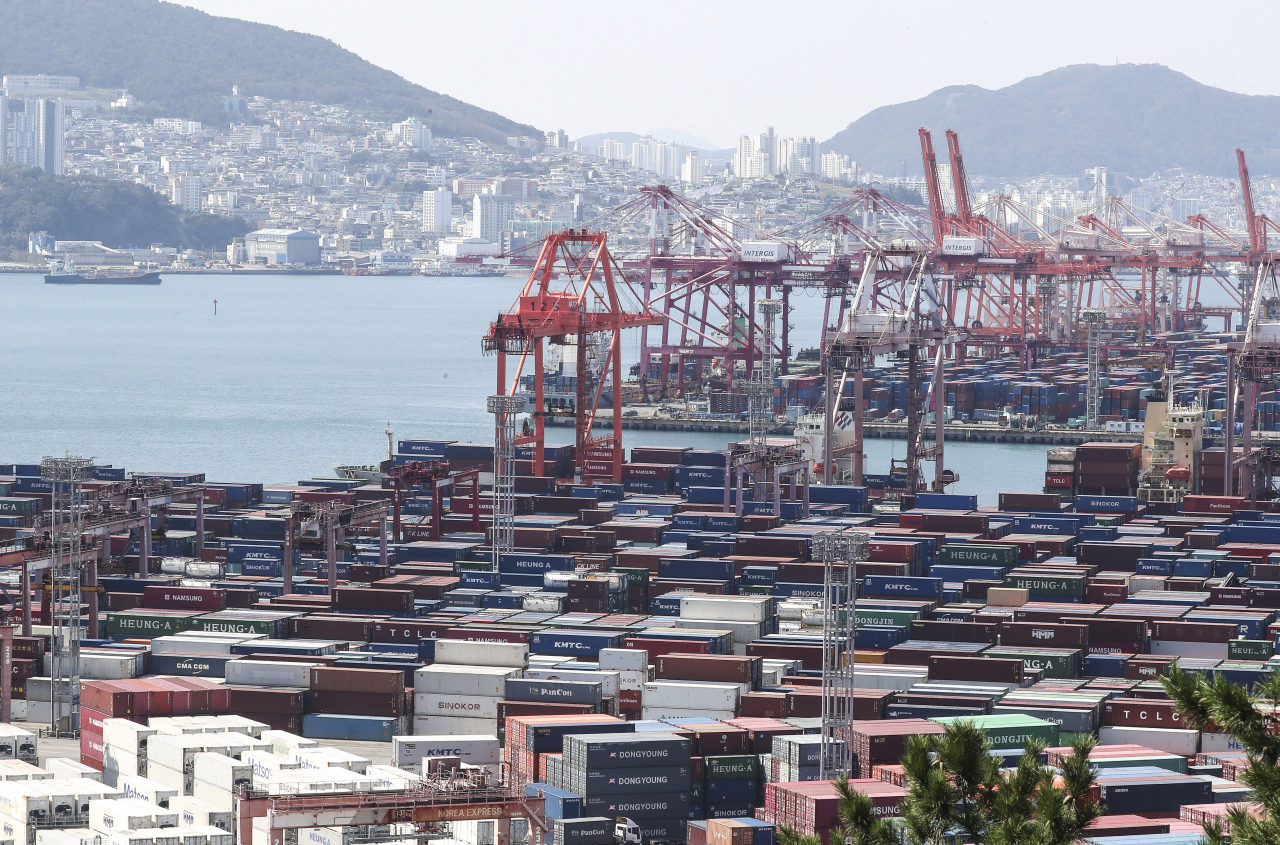 Containers of exports and imports are stacked at a pier in South Korea's largest port city of Busan last Friday. (Yonhap)