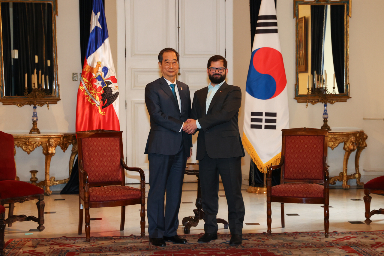 South Korean Prime Minister Han Duck-soo (L) and Chilean President Gabriel Boric pose for the camera before holding talks on Tuesday, in this photo provided by Han's office. (Han Duck-soo's offic)