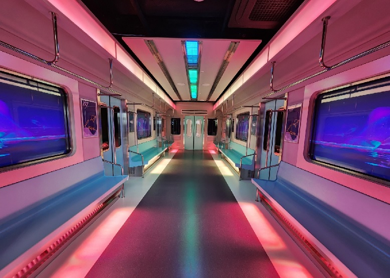 This filming set at K-Pop Ground resembles a subway train featured in girl group aespa's music video for “Black Mamba.