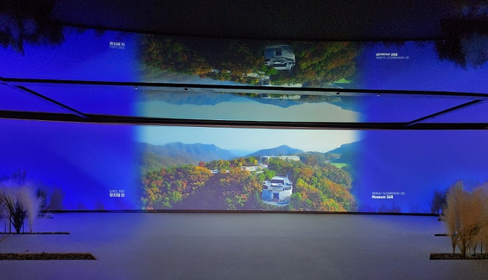 A large screen plays a video featuring places to visit for wellness tourism in Korea inside the HiKR Ground tourism center in Seoul. (Choi Jae-hee/The Korea Herald)