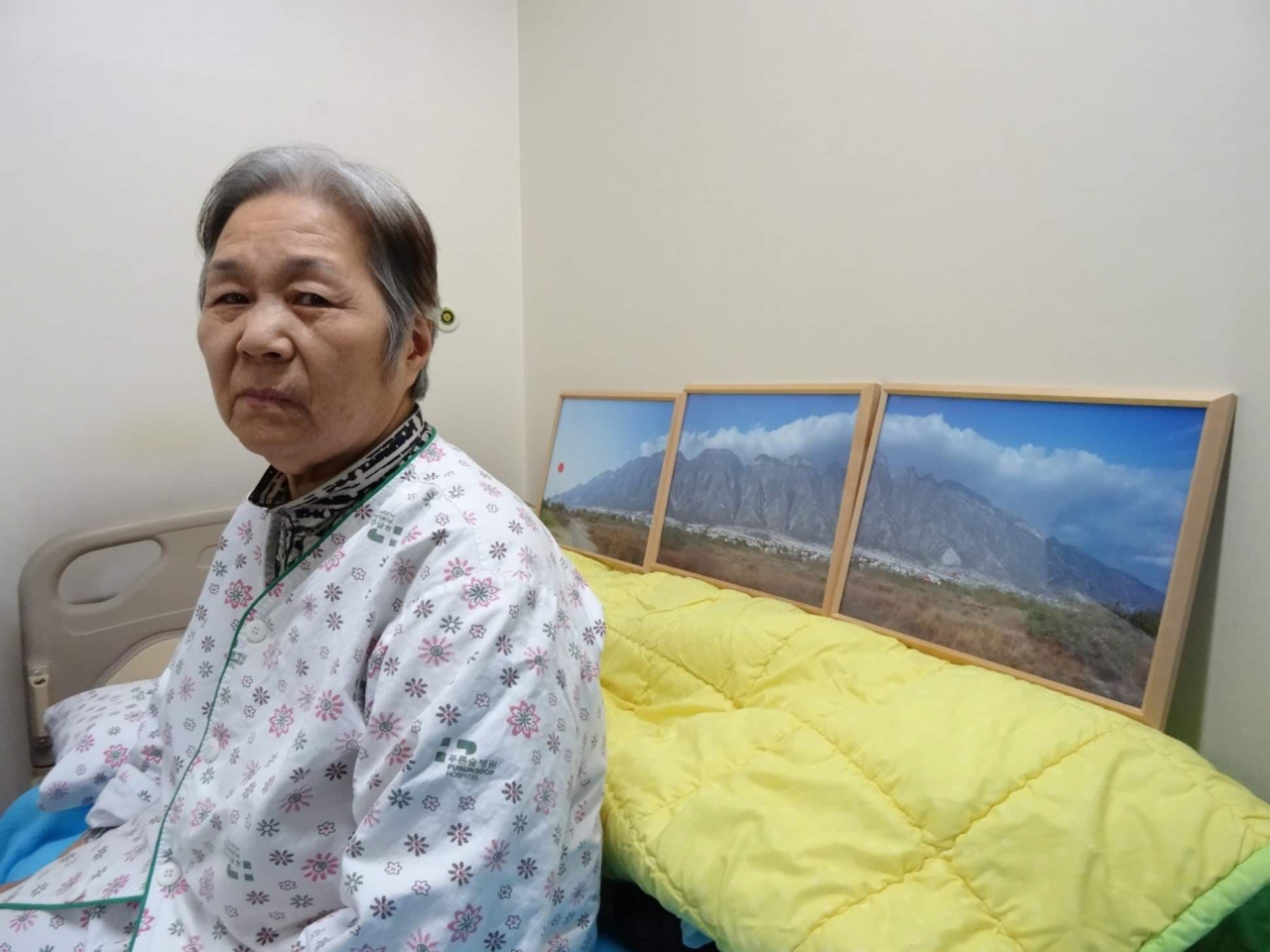 Area Park's mother sits in her room, with photos Park took in Mexico. (Area Park)