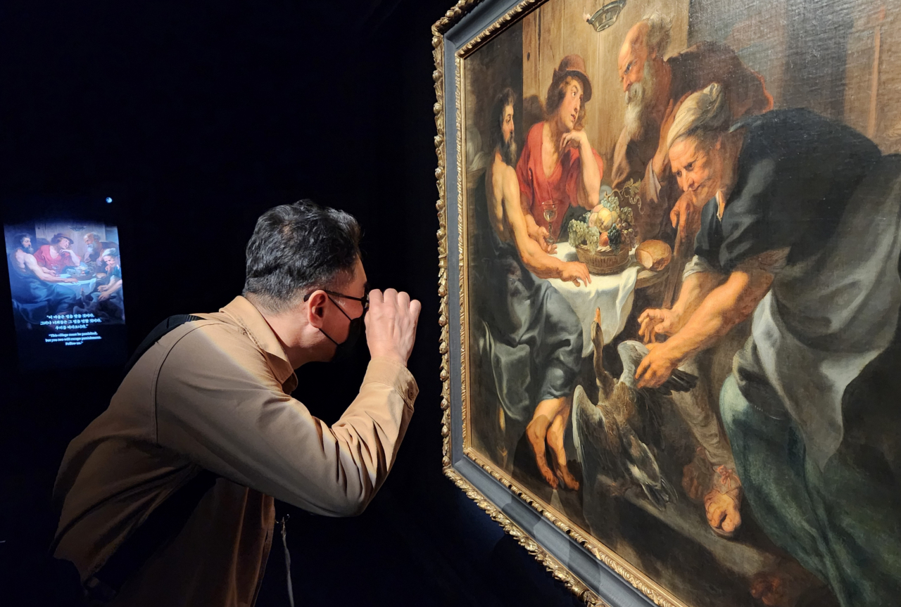 A visitor looks at Peter Paul Rubens' 