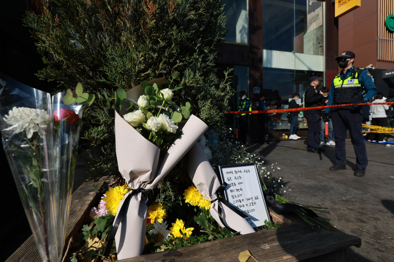 Flowers expressing condolences are placed near the accident scene in Itaewon, Seoul, Sunday. (Yonhap)