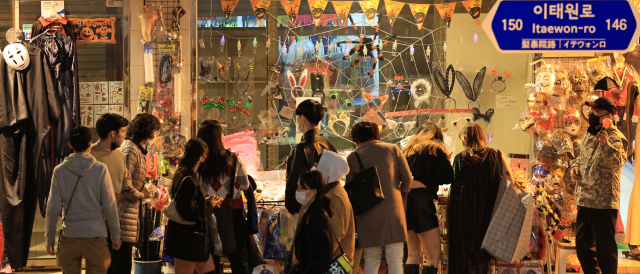 People look at Halloween decorations near Itaewon Station in Yongsan-gu, Seoul, on Friday. (Yonhap)
