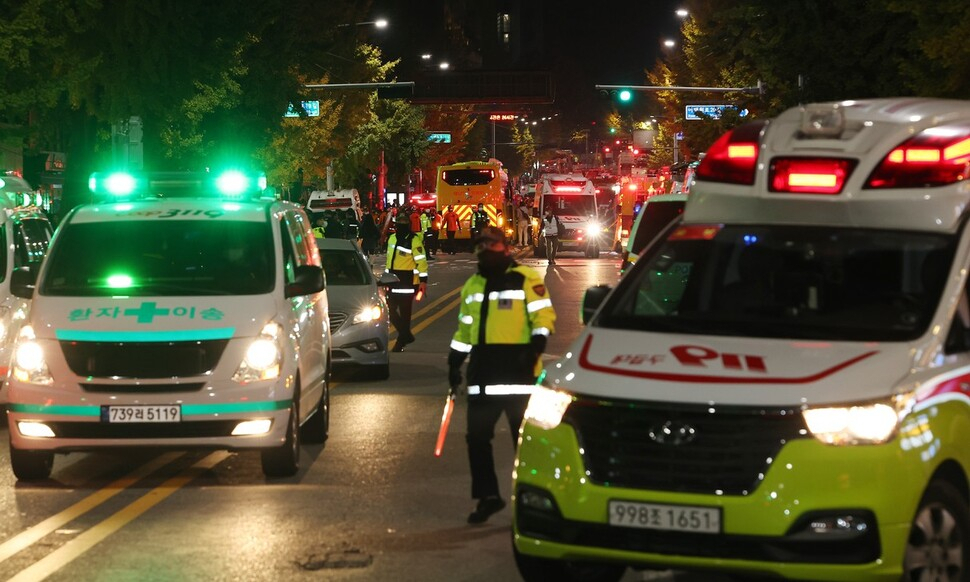 Police vehicles and ambulances are seen at Itaewon on Saturday night where a deadly crowd crush occurred. (Yonhap)