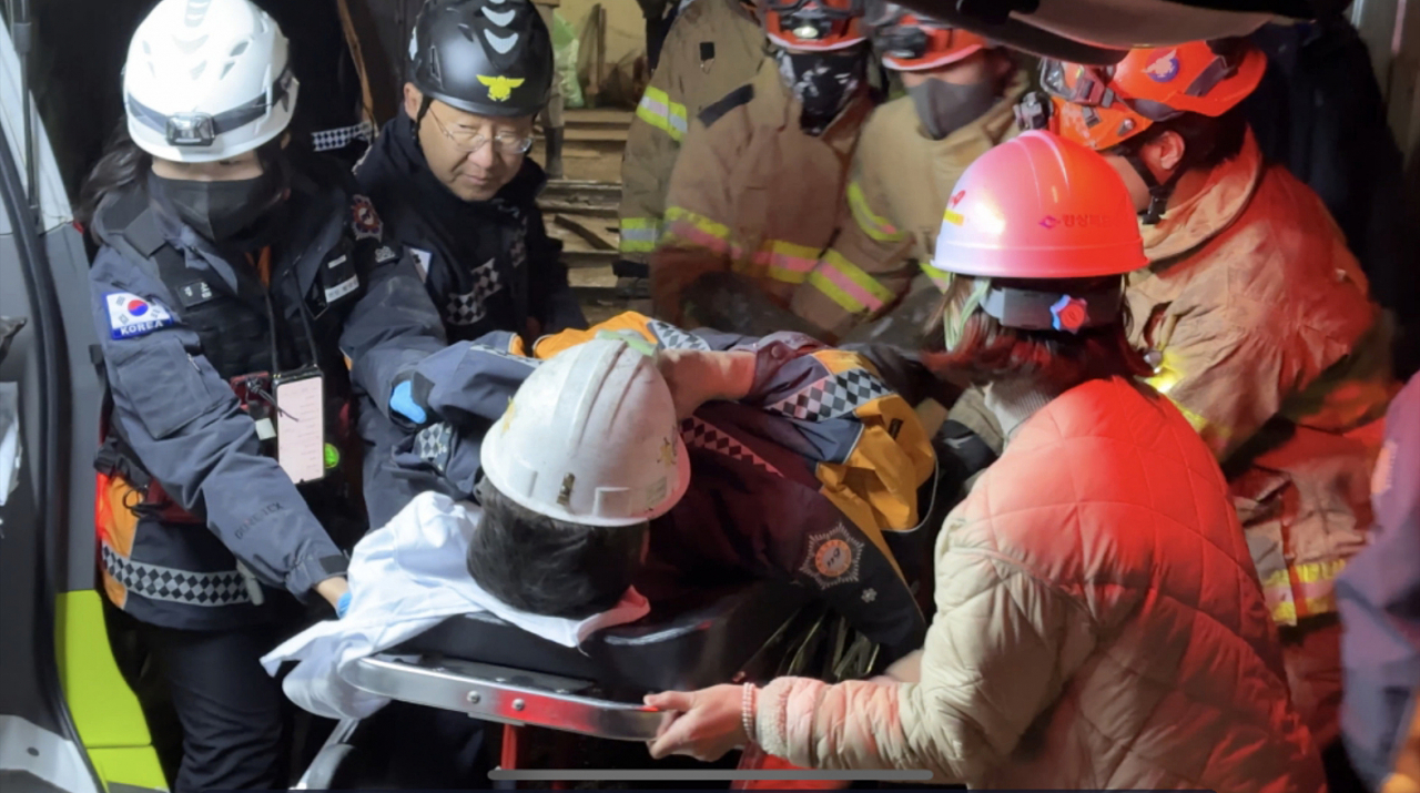 This photo shows a miner being carried into a hospital on Friday, after being rescued from a collapsed mine nine days after being trapped. (Gyeongbuk Fire Service Headquarters)