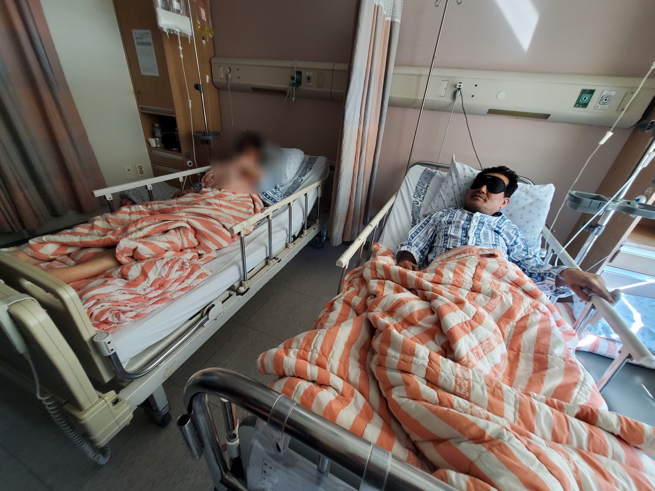 Two miners who have been rescued from collapsed mine after nine days stay at the patient’s room in Andong Medical Group Hospital, North Gyeongsang Province, Saturday. (Yonhap)