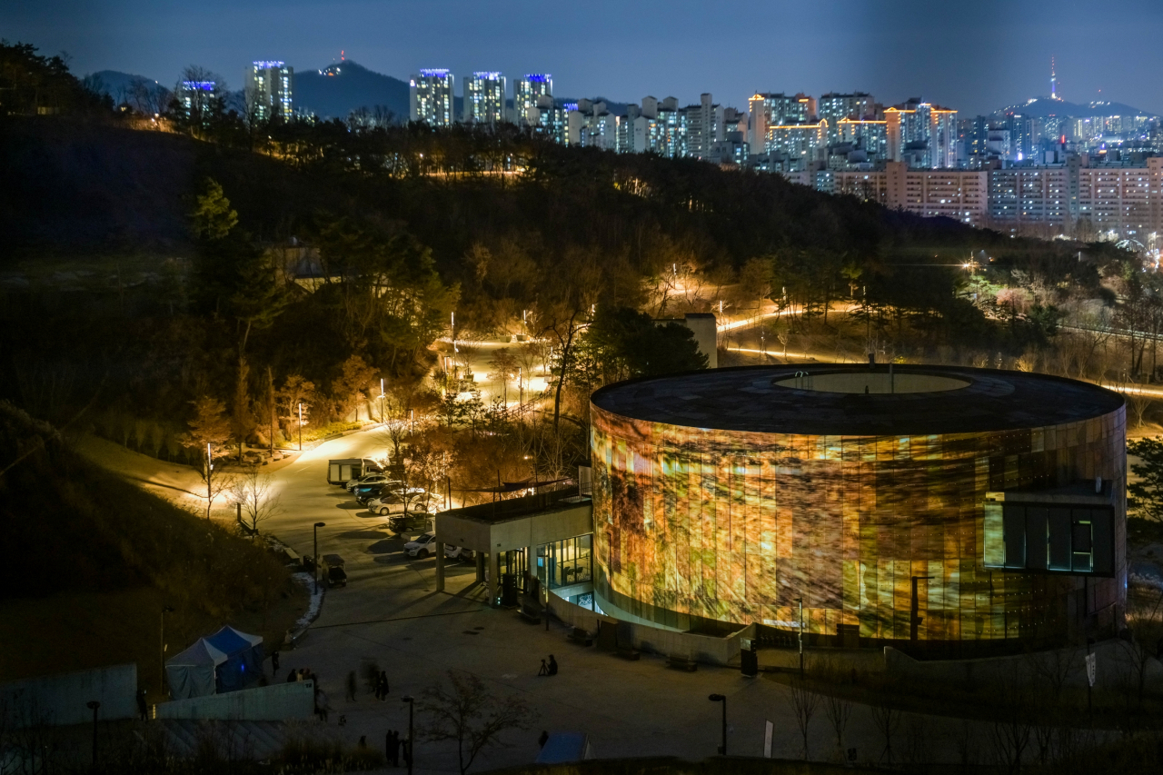 A renovated oil tank is illuminated at night with projection mapping, as part of a 2021 project at the Oil Tank Culture Park in Mapo-gu, Seoul. (Oil Tank Culture Park)