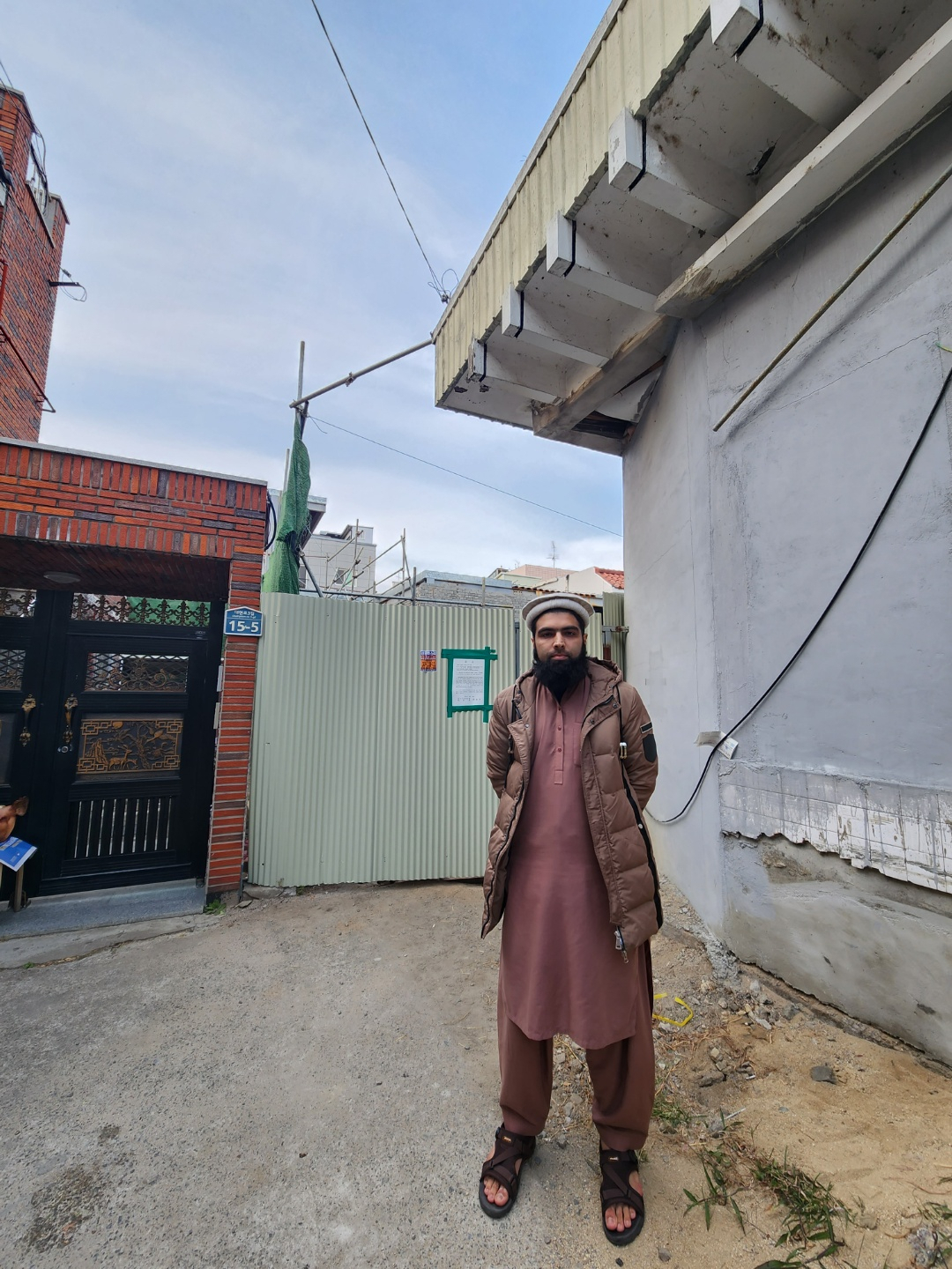Muaz Razaq, 26, a Muslim student at Kyungpook National University, stands in front of the construction site for a mosque in Daegu on Wednesday. (Choi Jae-hee/The Korea Herald)