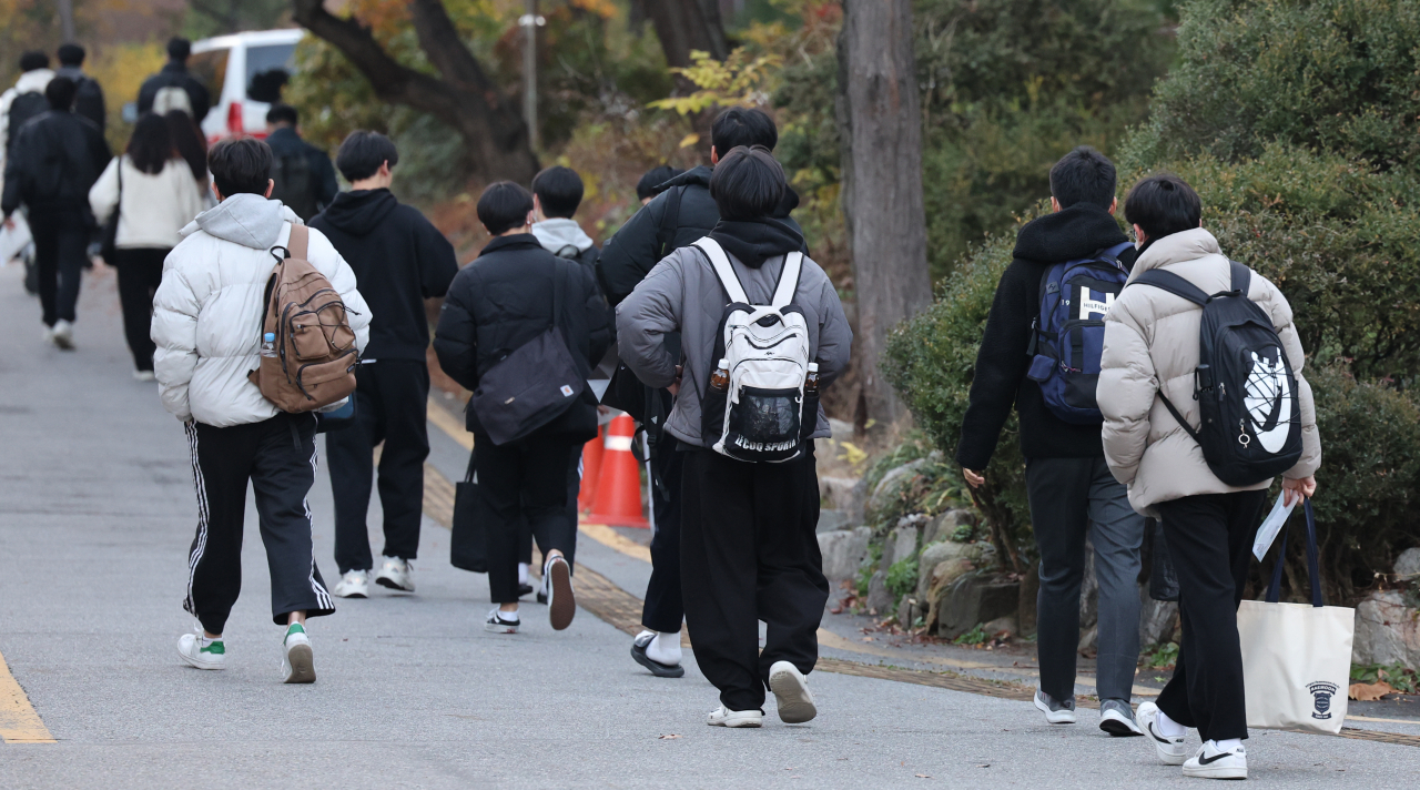 Students enter a high school in Seoul on Thursday to take the state-administered College Scholastic Ability Test. (Yonhap)