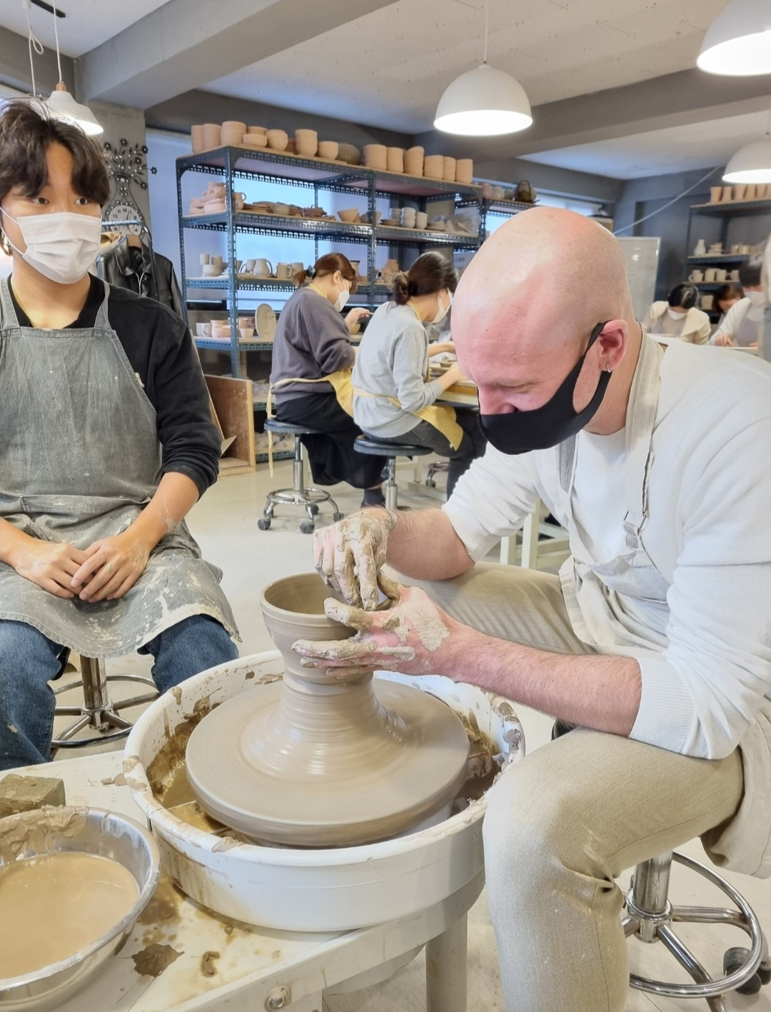 A student centers clay on a pottery wheel at Anna Pottery in Gwangjin-gu, Seoul. (Anna Pottery)