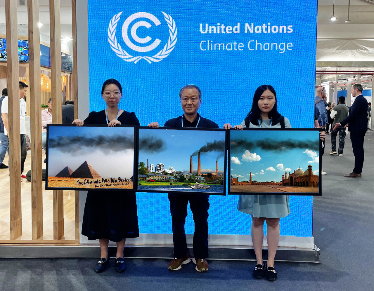 At the 21st Conference of the Parties (COP21) held in Paris in 2015, activists hold up a selection of photos to illustrate the message 