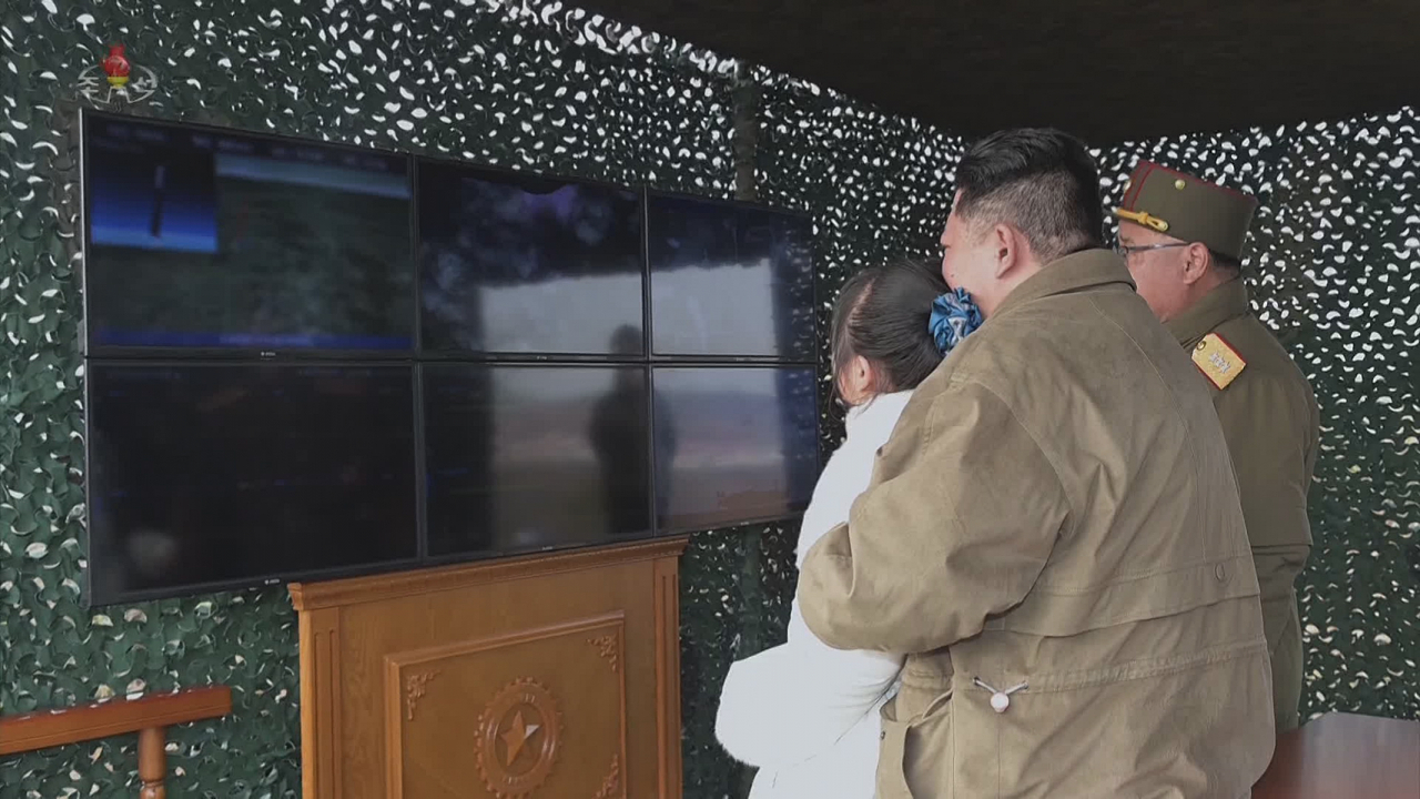 North Korean leader Kim Jong-un watches the missile launch with his daughter in this photo released by the Korean Central News Agency on Saturday. (Yonhap)