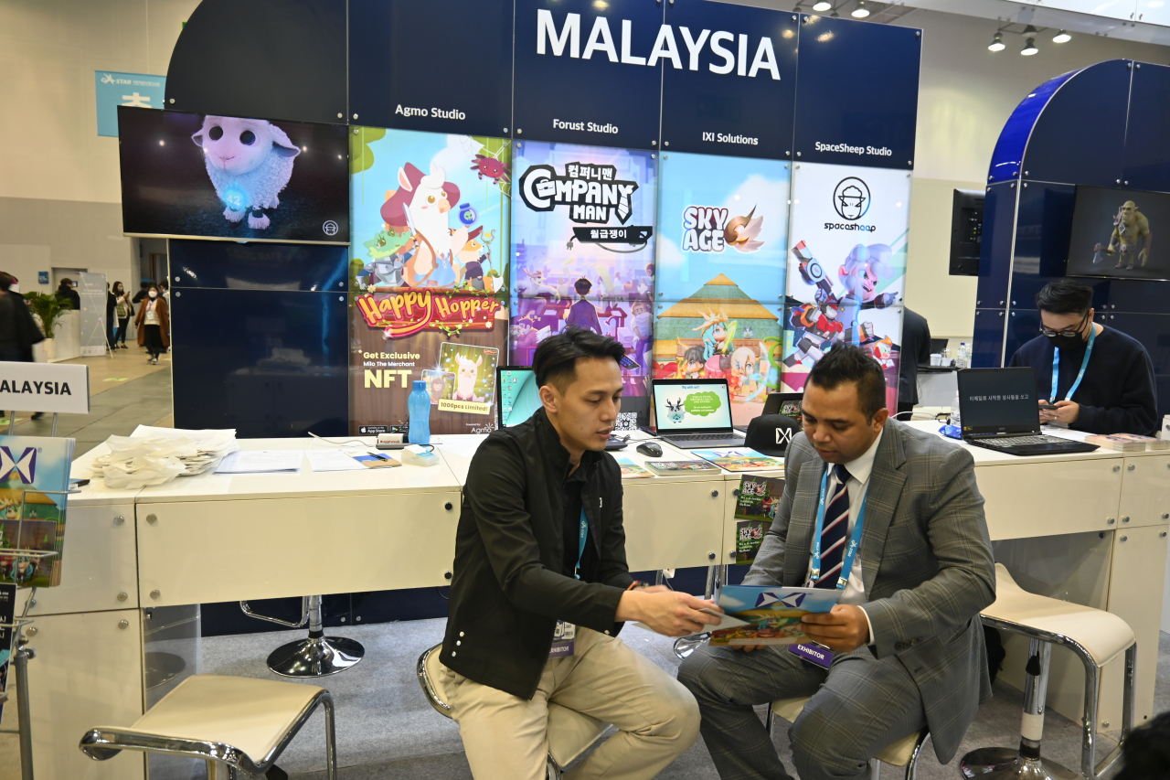 Lester CT Wai , managing director from IXI game shares his experience on creating digital contents with The Korea Herald at the ASEAN game pavilion at G-star in Bexco exhibition center, Busan on Thursday.(Sanjay Kumar/The Korea Herald)