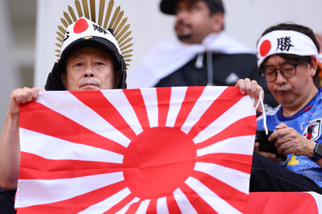 A Japanese fans hold up a Rising Sun Flag during the Group E match between Japan and Costa Rica on Sunday at the Ahmad bin Ali Stadium in Al Rayyaan, Qatar. (Yonhap)