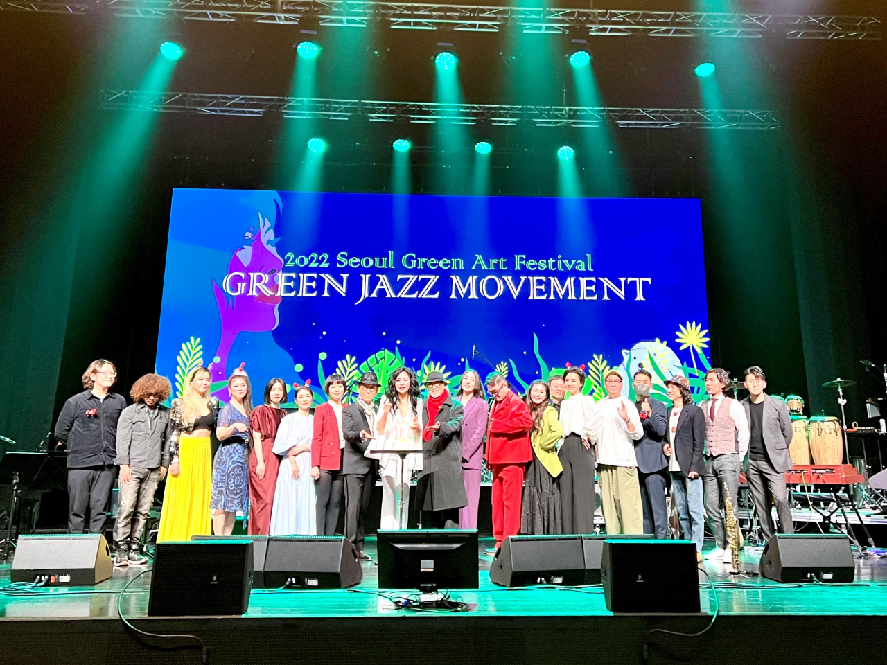 Jazz vocalists and musicians including Woong San (ninth from left) pose for photos after the Seoul Green Art Festival on Wednesday. (Korea Jazz Association)