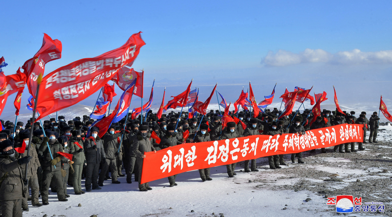 A brigade of young North Koreans climbed and toured Paektusan, a mountain straddling North Korea and China, in this photo released by state media Korean Central News Agency on Sunday. (KCNA-Yonhap)