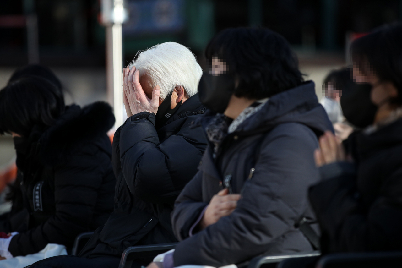 Bereaved families attend the 49th-day memorial service held at Jogye Temple in Jongno-gu, central Seoul, Friday. (Yonhap)