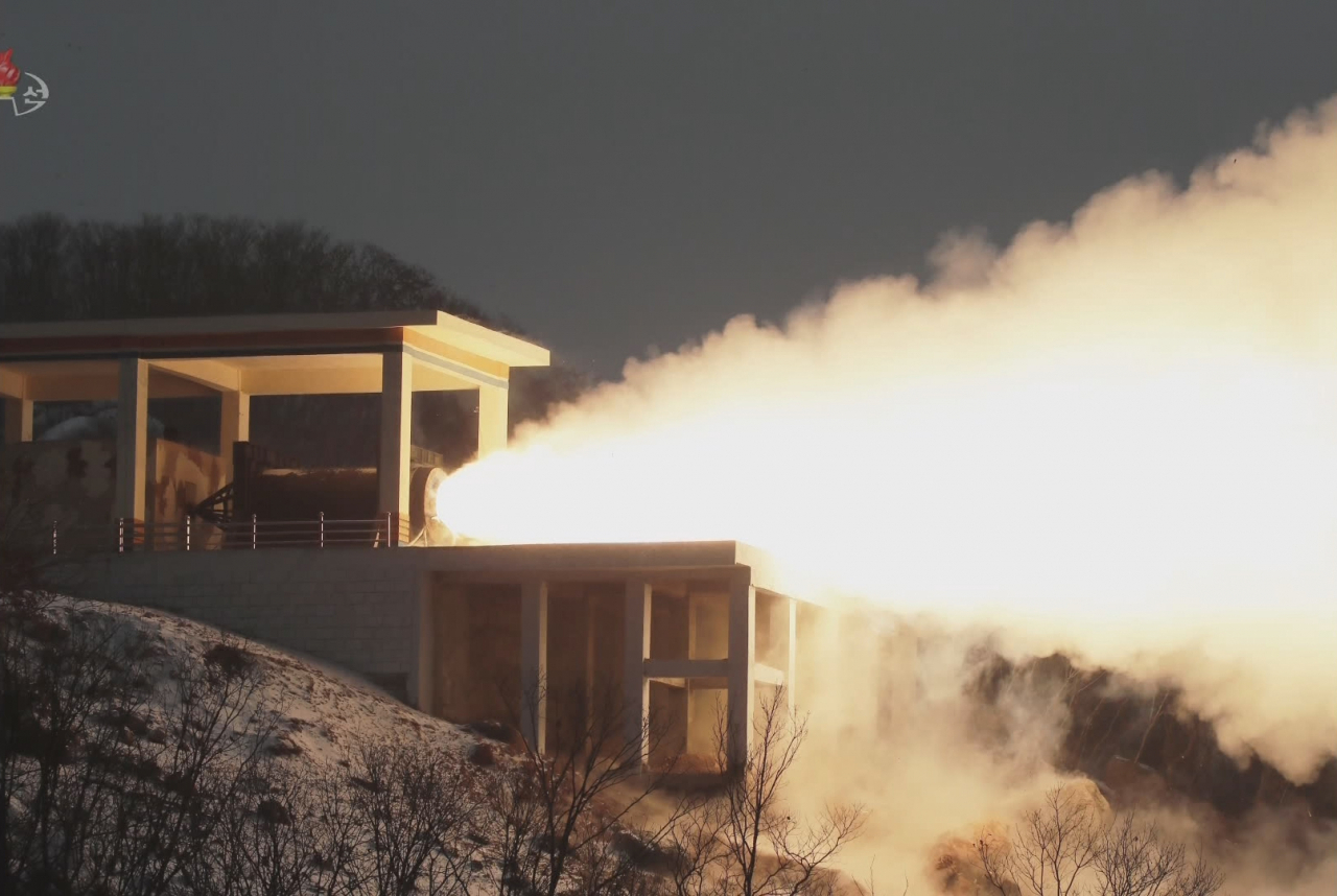 North Korea tests a “high-thrust solid-fuel motor” at the Sohae Satellite Launching Ground in this photo released by the Korean Central News Agency on Friday. (KCNA-Yonhap)