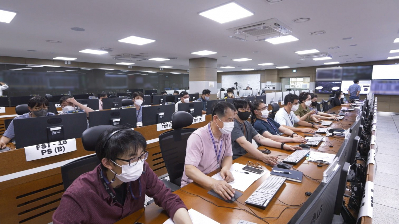 This photo provided by the Korea Aerospace Research Institute shows its aerospace engineers conducting a trajectory correction maneuver operation for the South Korean lunar orbiter Danuri. (Korea Aerospace Research Institute)