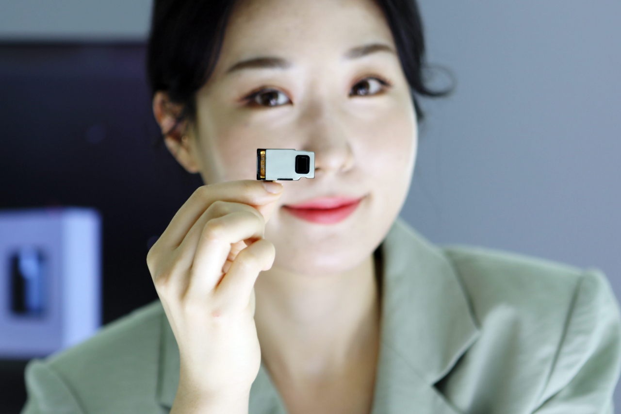 A model holds up LG Innotek's newest optical telephoto zoom camera module. (LG Innotek)
