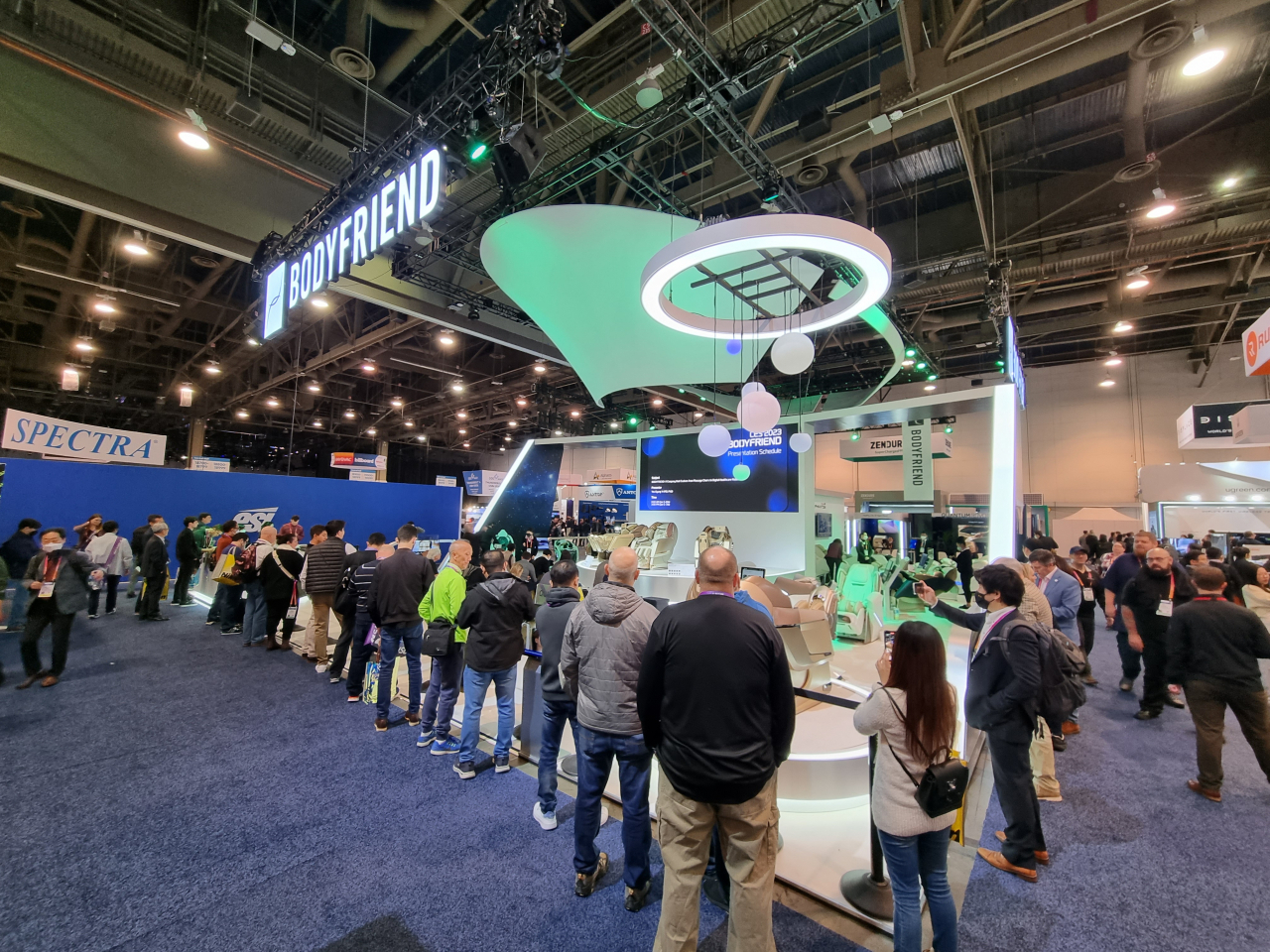 People line up in front of Bodyfriend's exhibition at CES 2023 to try out the company's massage chair on Friday. (Kan Hyeong-woo/The Korea Herald)