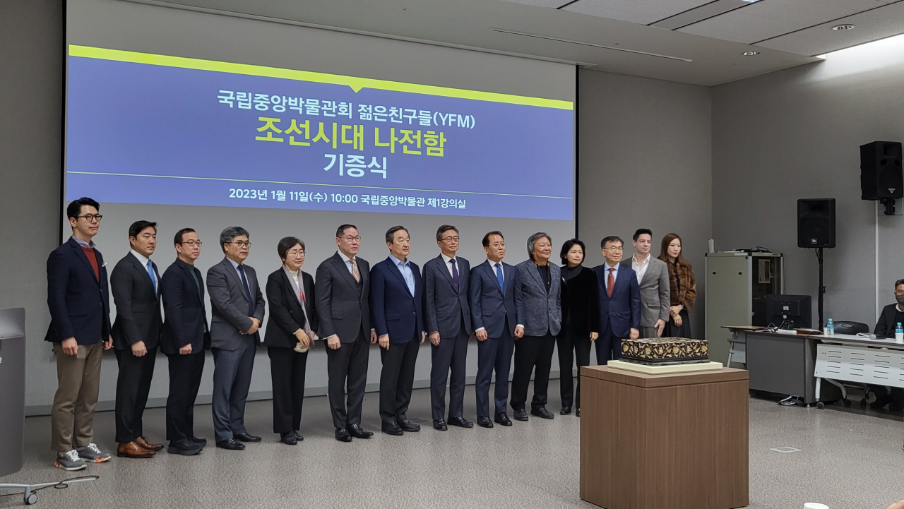Members of the Young Friends of the Museum pose for a photo with National Museum of Korea Director Yoon Sung-yong (sixth from right), during a press conference held at the National Museum of Korea in Yongsan, central Seoul, Wednesday. (Kim Hae-yeon/ The Korea Herald)