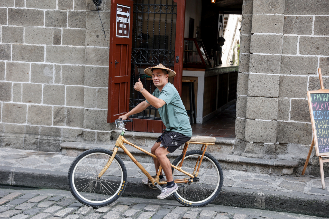 A man rides a bamboo bike in Intramuros, the historic walled city in Manila, Philippines. (The Blend)