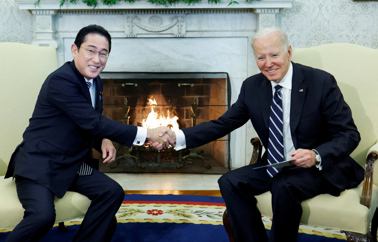 US President Joe Biden shakes hands with Japan's Prime Minister Fumio Kishida during a bilateral meeting in the Oval Office at the White House in Washington, US, on Friday. (Reuters)