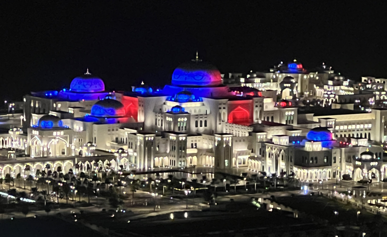 Qasr Al Watan, the presidential palace of the United Arab Emirates, is illuminated in red and blue for the colors of the taegeuk symbol that represents South Korea, celebrating the state visit by President Yoon Suk Yeol on Sunday. (Yonhap)