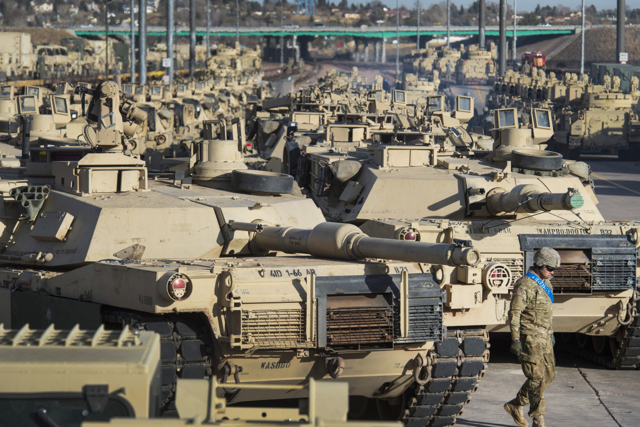 A soldier walks past a line of M1 Abrams tanks, Nov. 29, 2016, at Fort Carson in Colorado Springs, Colorado. The Biden administration on Wednesday announced its plans to provide Ukraine with 31 M1 Abrams tanks, which the required number to equip an entire Ukraine tank battalion. (File Photo - The Gazette via AP)