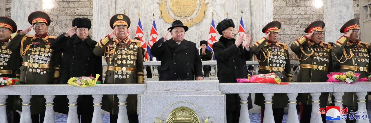 North Korean leader Kim Jong-un (C) salutes during a military parade at Kim Il Sung Square in Pyongyang on the night of Feb. 8, 2023, to mark the 75th founding anniversary of the Korea People's Army, in this photo released by the North's Korean Central News Agency. (Yonhap)