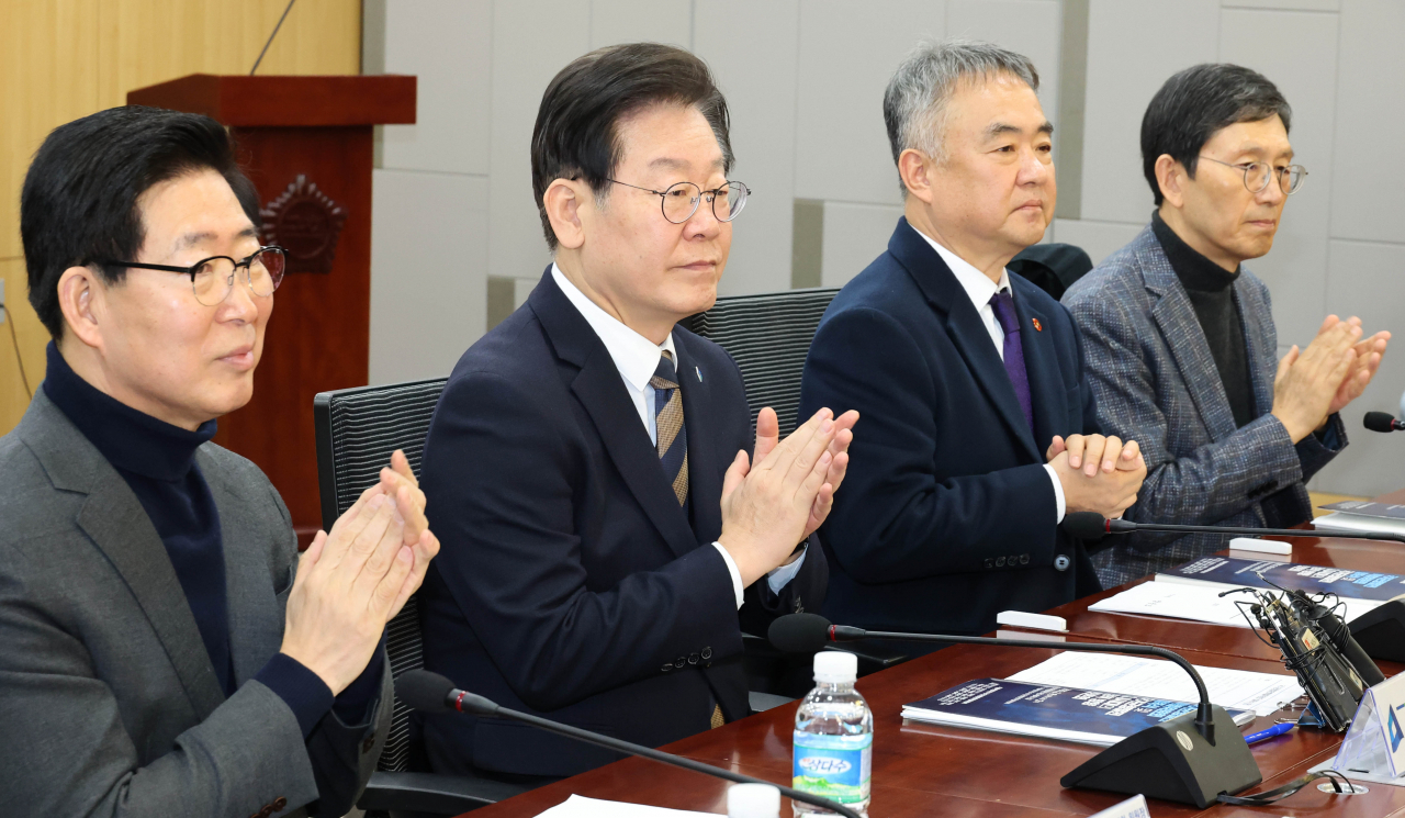 Democratic Party Chair Lee Jae-myung (second from left) attends a meeting at the National Assembly on Thursday. (Yonhap)