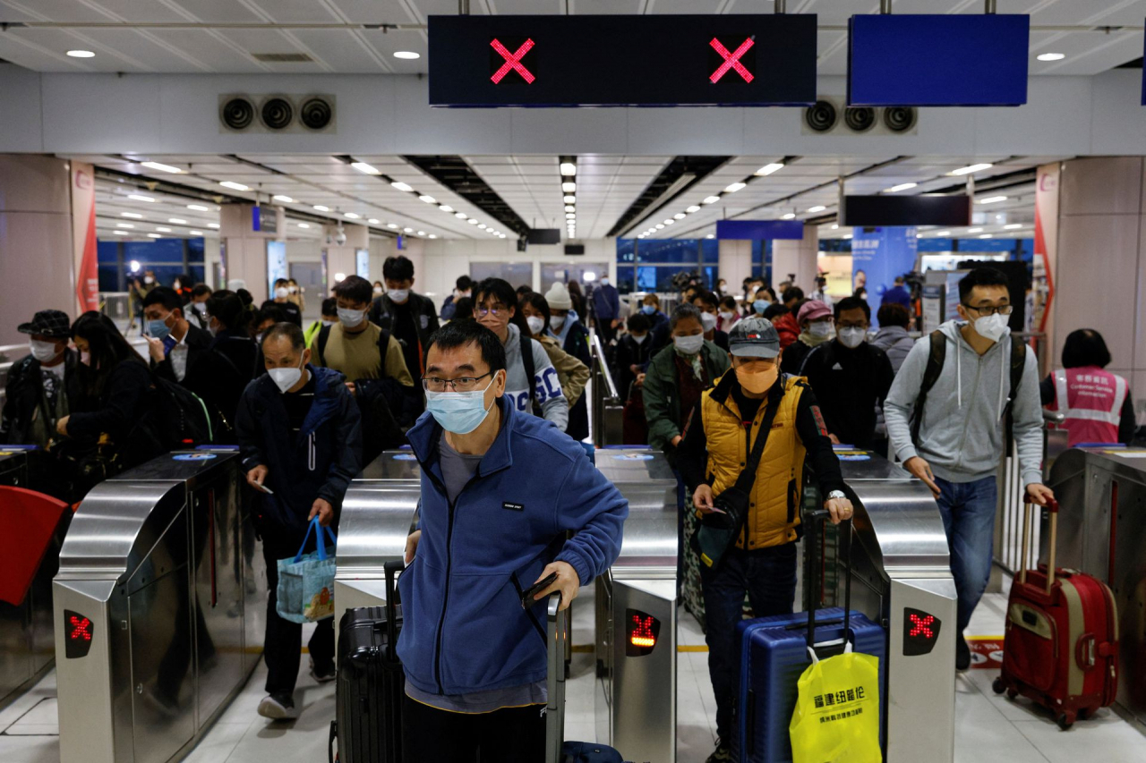Travelers arrive at Hong Kong's Lok Ma Chau border checkpoint on the first day China reopens the border amid the COVID-19 pandemic in Hong Kong, China, Jan. 8. (Reuters)